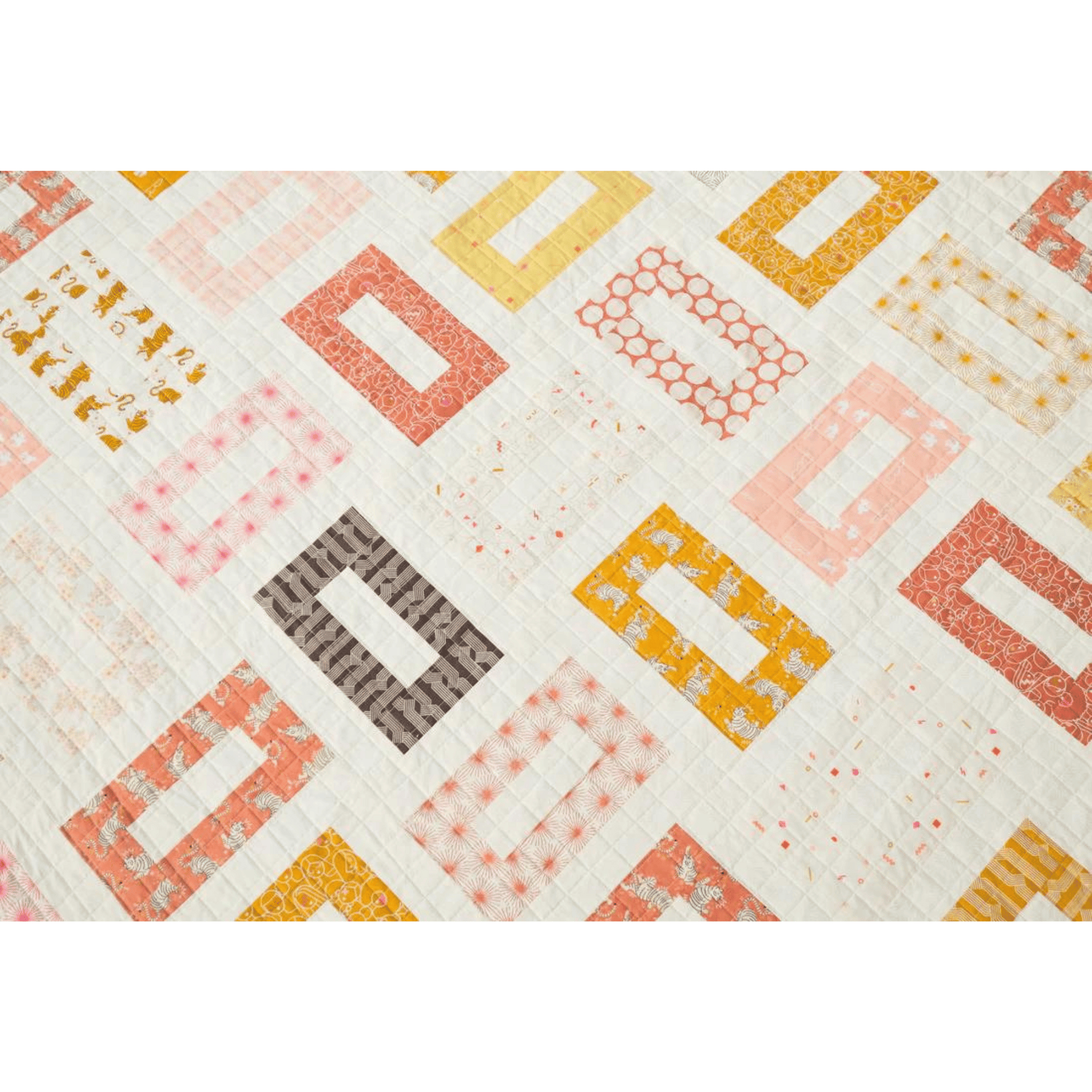 The Orla Quilt features hollow rectangles in pinks, yellows, reds, and golds on a white background.