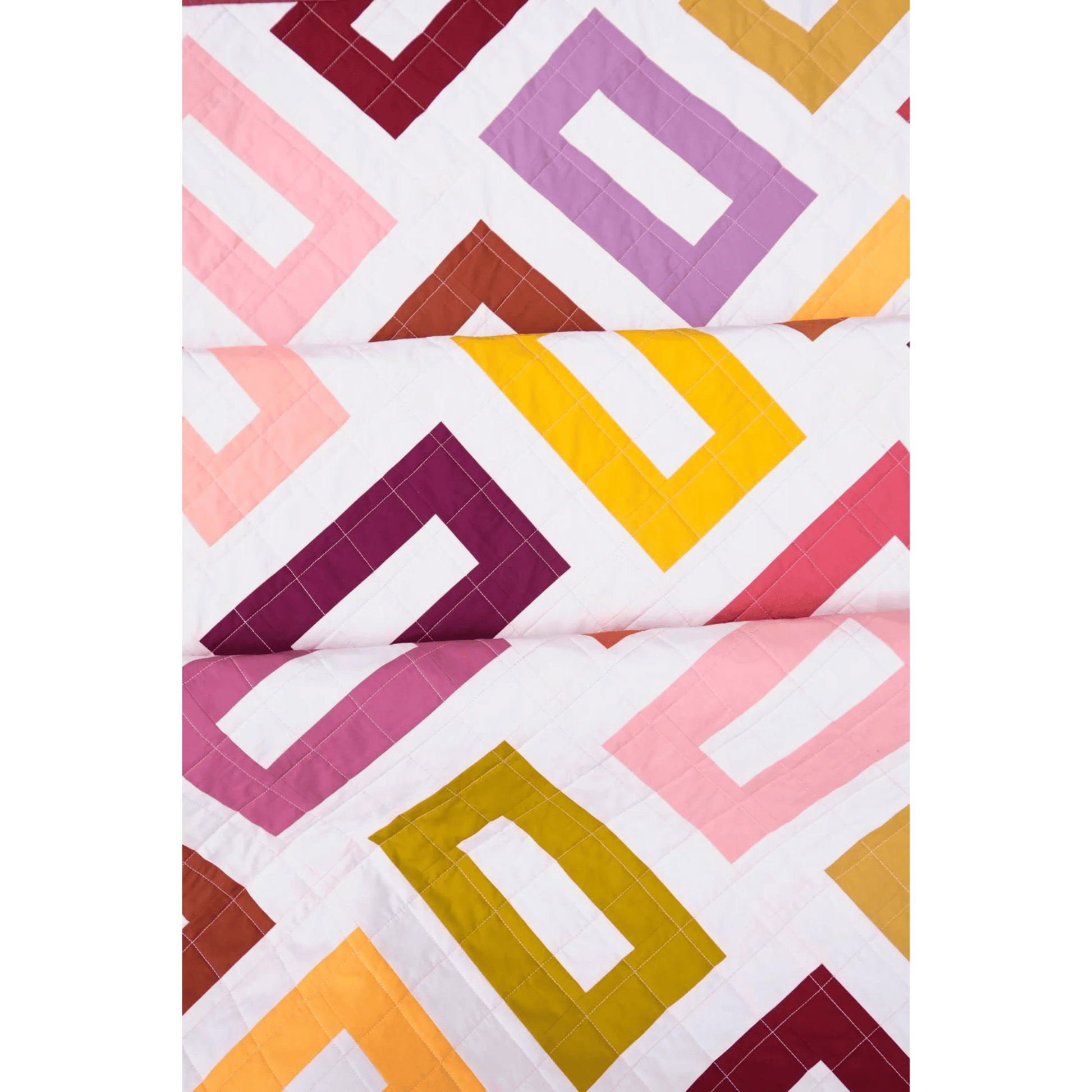 The Orla Quilt features a close-up view of hollow rectangles in pink, yellow, purple, and gold on a white background.