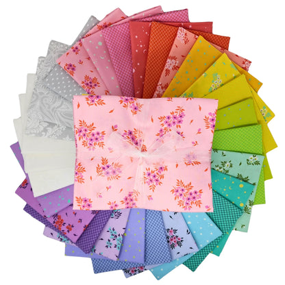 Colorful fabric swatches are arranged in a circular pattern with a half-yard bundle in the center.
