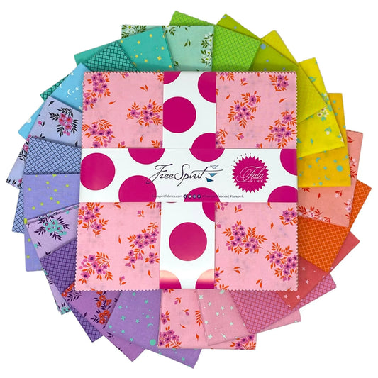 Colorful fabric swatches are arranged in a circular pattern with a 10-inch layer cake in the center.