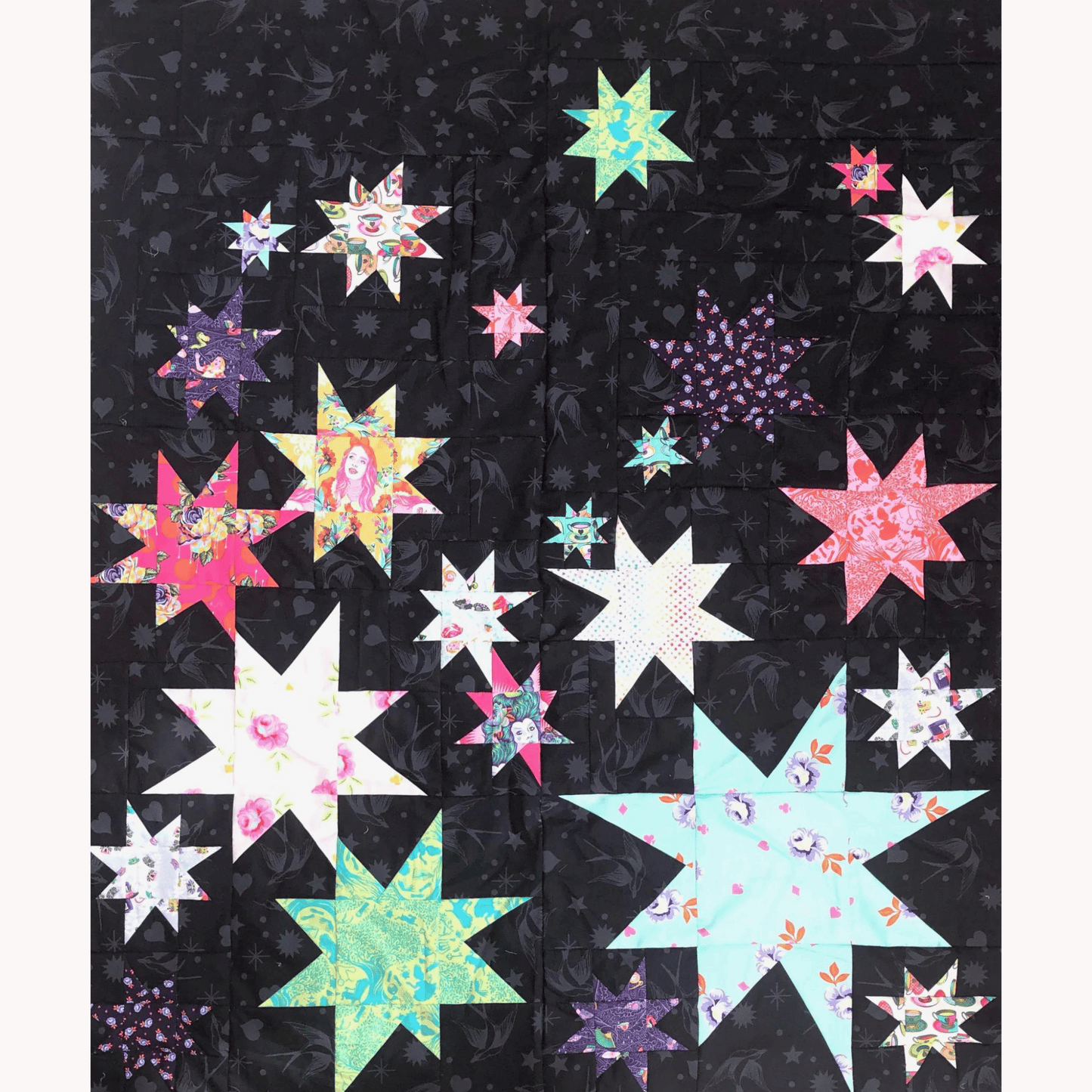 The Vela Quilt is a fun take on wonky stars. This modern quilt features various sized star blocks made with Tula Pink's Curiouser & Curiouser collection pieced with her Fairy Flakes in Ink background fabric.