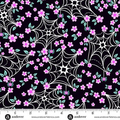 Pattern of cartoon-style spider webs and pink flowers on a black background with a ruler for scale
