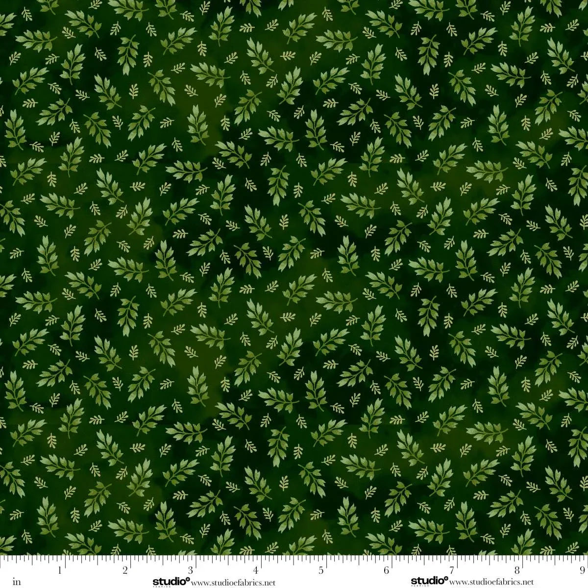 Green fabric with small leaf pattern.  Ruler at the bottom for scale.