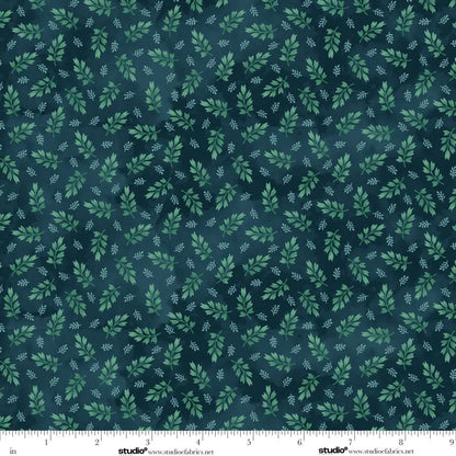 Fabric with green leaf pattern on a dark blue background. Ruler at the bottom for scale.