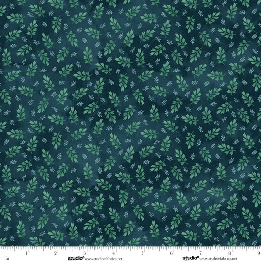 Fabric with green leaf pattern on a dark blue background. Ruler at the bottom for scale.