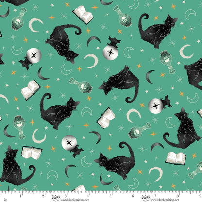Pattern of black cats, books, and potion bottles on a teal-green background with a ruler for scale.