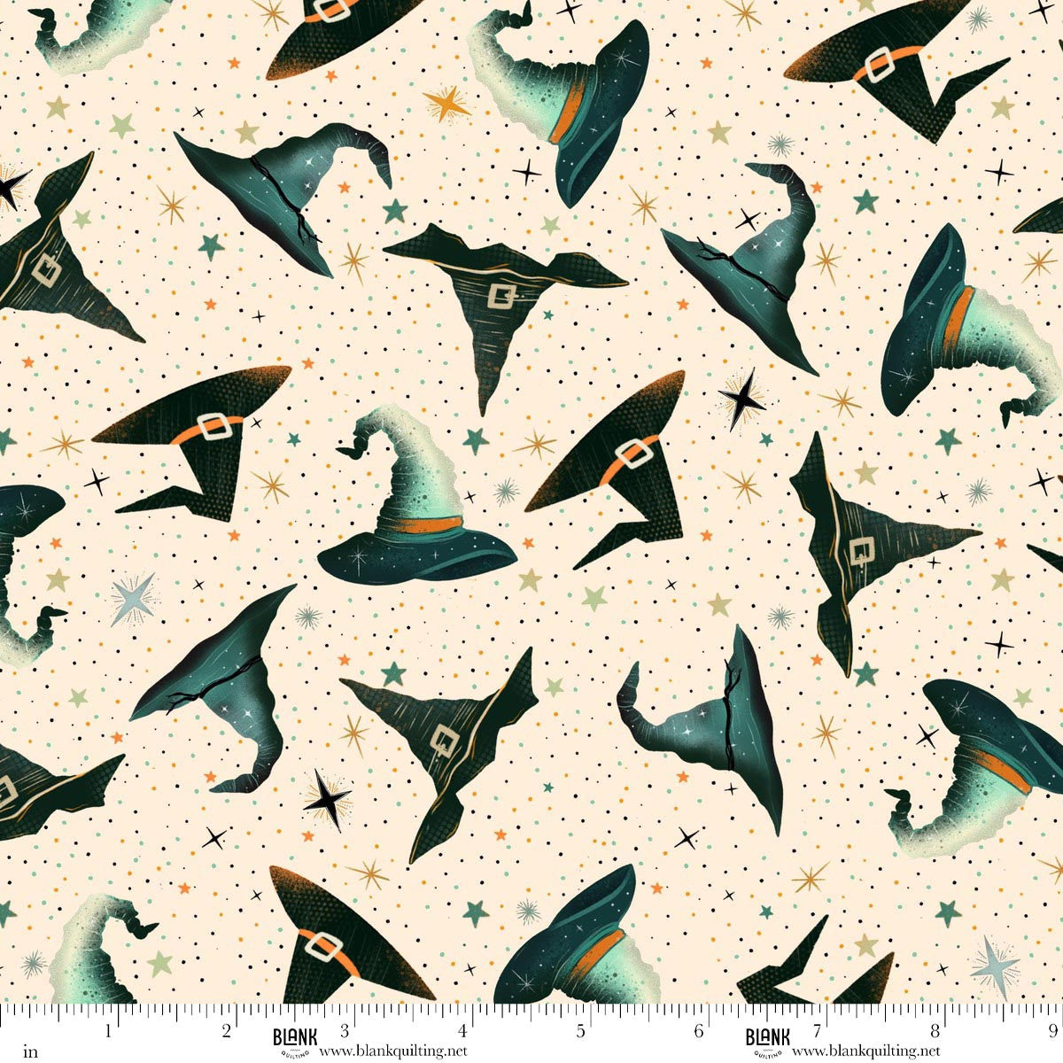 Pattern of witch hats on a beige background with stars. Ruler for scale.