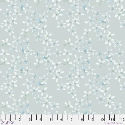 Natural Affinity Petals in Fog features small delicate watercolor flowers in soft white, blue, and green pastels tossed across a soft grey background.