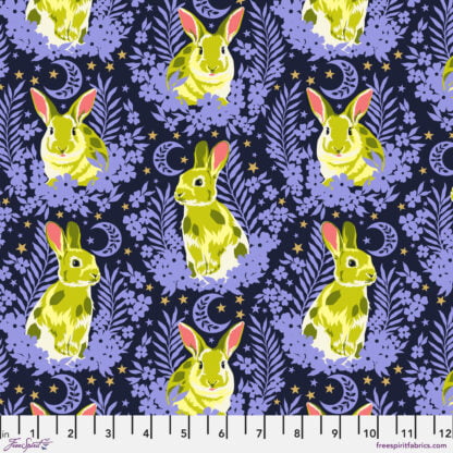 Besties Hop To It in Bluebell features lime green bunnies nestled among periwinkle flowers on a dark navy blue background. Metallic gold stars glitter in the background.