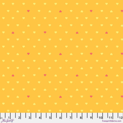 Besties Unconditional Love in Buttercup features tiny yellow and red hearts arranged in a geometric grid pattern on a warm butterscotch background.