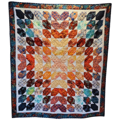 The Hermosa Mini Petals Quilt Kit makes a quilt that lives up to its name - beautiful! Combining dark navy blues, rusty reds, warm peachy corals, and neutral tans with pastel sashing, this layer cake-friendly pattern is perfect for beginner quilters and up.